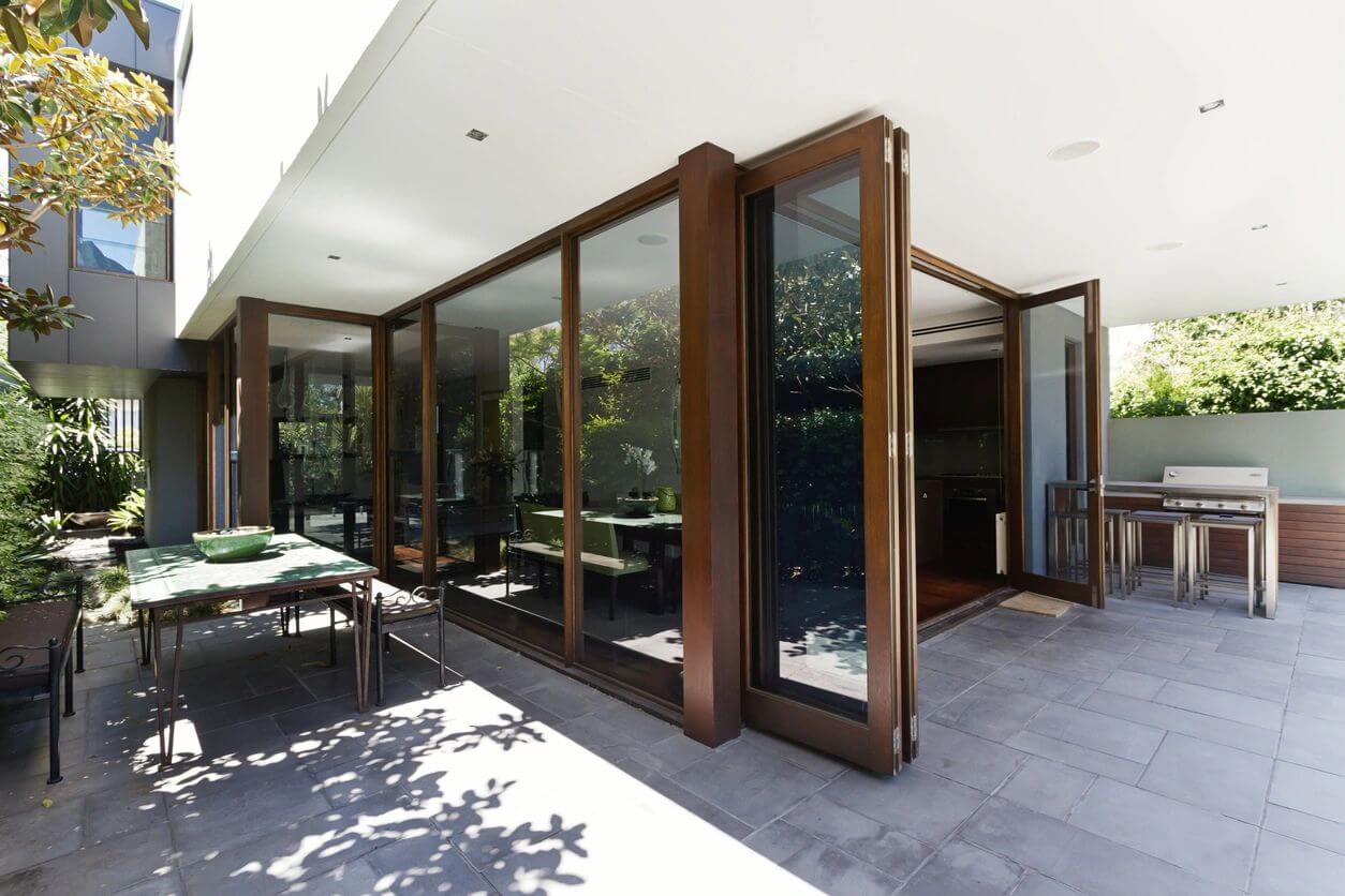 A patio with sliding glass doors open to the outside.